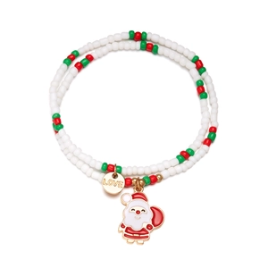 Detail of Christmas beaded bracelet with Santa Claus charm and LOVE engraved gold disc