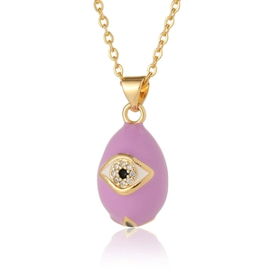 Macro shot of purple enamel evil eye pendant with micro-set zircon on gold chain