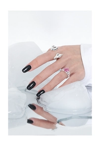 Macro detail of S925 silver ring set with square pink gemstone and woven chain band style