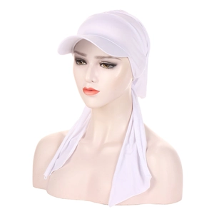 Detail view of the white turban cap with brim and long tail made of elastic fabric