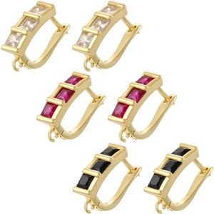 Close-up of gold square gemstone hoop earrings in white, ruby red and black colors