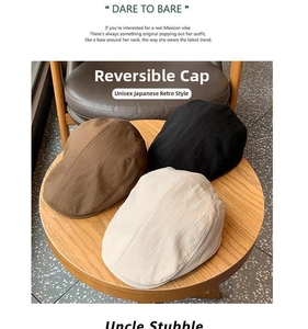 Detailed view of vintage newsboy caps in brown, black and beige on a wooden stool