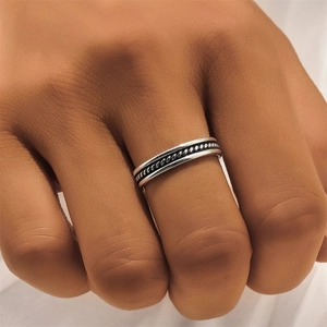 Detailed macro view of a vintage silver ring featuring an intricate woven texture pattern