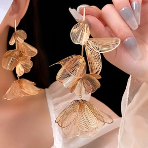 Golden woven hollow flower drop earrings in layered petal design for fashion women