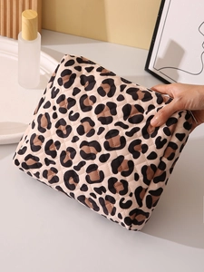 Close-up of quilted leopard print cosmetic bag being held to show high-quality fabric texture