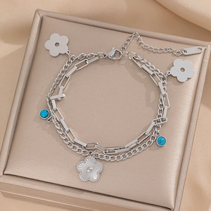 Double-layer silver stainless steel bracelet featuring blue gemstones and flower charms