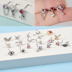 Assorted stainless steel nose studs with heart, moon, and butterfly cubic zirconia designs