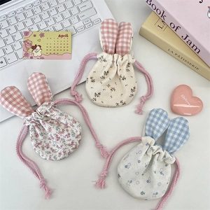 Three floral drawstring pouches with cute bunny ears for makeup and accessory storage