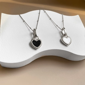 Double-sided heart pendant necklace in titanium steel with black and white enamel finish