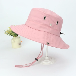 Close-up of pink wide-brim bucket hat with chin strap and adjustable toggle details