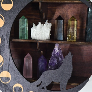 Detailed close-up of dark wolf-silhouette crescent moon wooden crystal display shelf