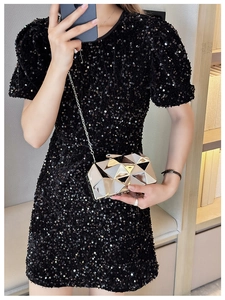 Detail of silver geometric mirror clutch bag with 3D triangle pattern and metal chain