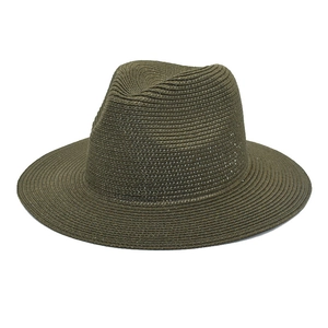 Detailed view of olive green straw fedora hat featuring spiral woven texture and wide brim