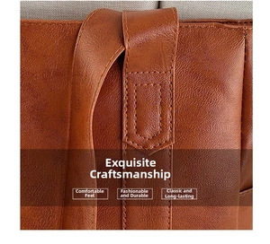 Detailed view of reinforced stitching and litchi texture on a brown leather tote bag