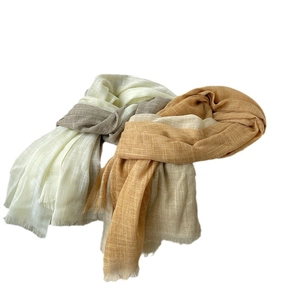 Elegant cotton linen scarf with gradient colors and fringe details on white background