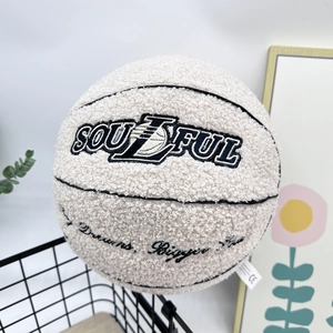 Detail of plush basketball pillow with Soulful embroidery in a decorative basket