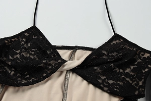 Dettaglio del pizzo nero e del design a nodo su un abito estivo attillato elegante