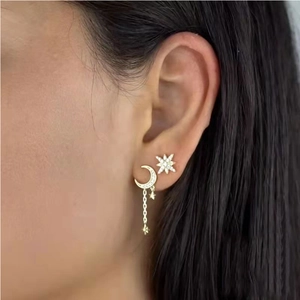 Elegant gold-plated star and moon tassel earrings set with zircon stones on model