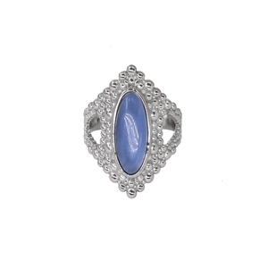 Detailed macro view of a silver gemstone ring with blue oval stone and textured band