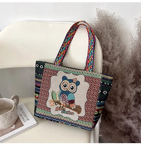 Detail of embroidered owl pattern and Home Sweet Home text on small canvas tote bag
