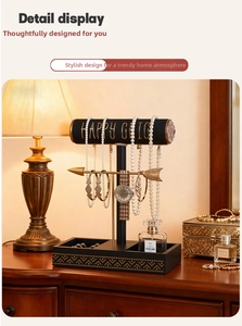 Close-up of T-bar jewelry display stand with golden accents and tiered storage base