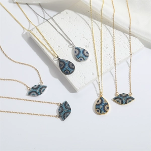 Minimalist evil eye necklaces with colorful crystals on white stone and silk