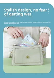 Close-up of a white portable compressed raincoat being placed into a small handbag