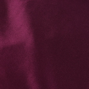 Detailed close-up of dark purple satin fabric showing smooth texture and elegant luster