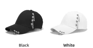 Close-up of punk style baseball caps with silver metal rings and hanging chains