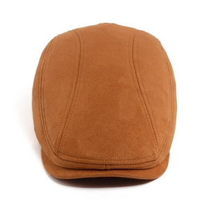 Top view detail of brown suede flat cap showing stitched panel construction and texture