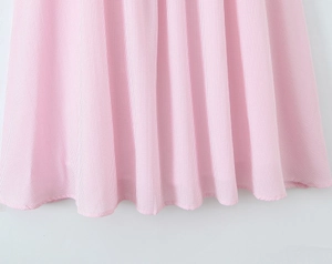 Close-up of soft pink and white striped fabric texture for a square neck dress