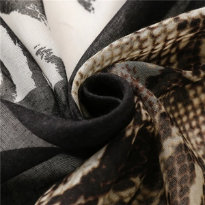 Macro shot of breathable zebra and leopard print scarf fabric with soft fringe details