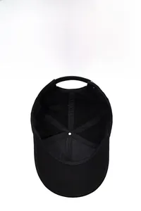 Detail of black cotton baseball cap interior showing reinforced seams and eyelets