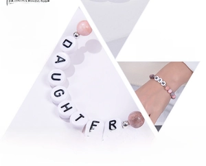 Detail of pink zebra jasper beads and Daughter letter charm on elastic stone bracelet
