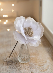 Close-up of a white 18cm artificial velvet magnolia flower with gold glitter edges