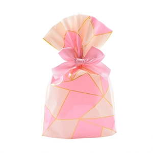 Pink and beige plaid gift bag with gold geometric patterns and a pink satin bow