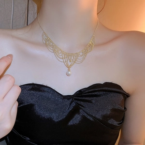 Close-up of 24K gold plated lace necklace with 12mm pearl and vintage palace fringe