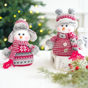 Christmas snowman plush doll set with red knit accessories on festive background