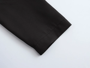 Close-up of the black synthetic fiber fabric and detailed texture on the sleeve cuff