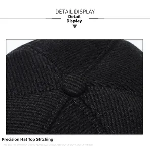 Détail des coutures précises de la couronne sur la casquette d'hiver en sergé noir