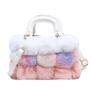 Detail of multi-color plush handbag with white faux leather handles and metal hardware