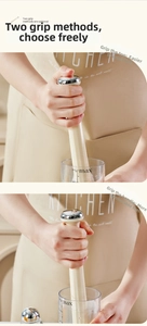 Dual-grip demo of a cream-colored muddler with 500ml scale cup for crushed lemon tea
