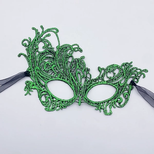 Close-up of vibrant green lace phoenix mask with intricate hollow patterns and black ribbons