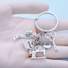 Detail of tailor theme keychain with scissors, sewing machine and iron charms