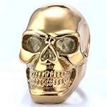 Close-up of golden vintage punk skull ring made of durable stainless steel with metal luster