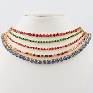 Detail view of colorful round and marquise cut zircon gemstones on gold-plated box chains