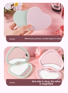 Detail of heart-shaped portable compact mirror with double-sided HD and magnifying views