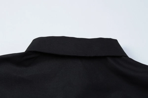 Detailed close-up of the black knit collar and stitching on the short sleeve t-shirt