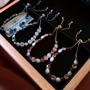 Detailed shot of vintage adjustable bracelets with colorful stones in a jewelry box