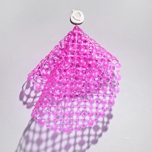 Pink non-slip PVC bathroom mat with suction cups hanging on a hook for shower safety